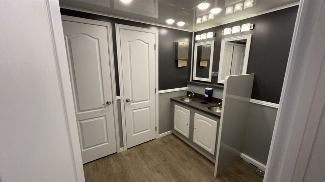 interior luxury restroom trailer private stalls vanity mirrors hardwood floors Alabama